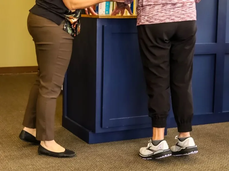 A therapist watching a patient&rsquo;s feet and shoes as they walk in the Motion Matters clinic